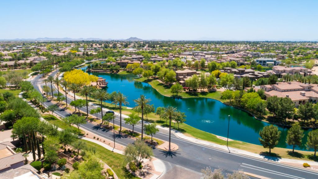 Neighborhood in Chandler, AZ with beautiful blue pond and surrounding greenery.