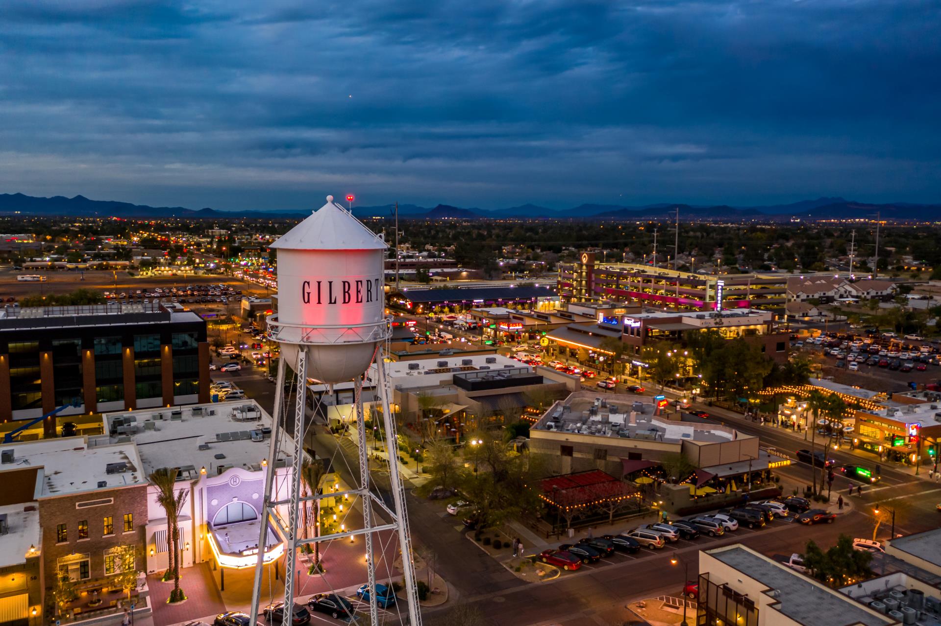 Town in Gilbert, AZ in the evening with buildings, streets, and beautiful lights.