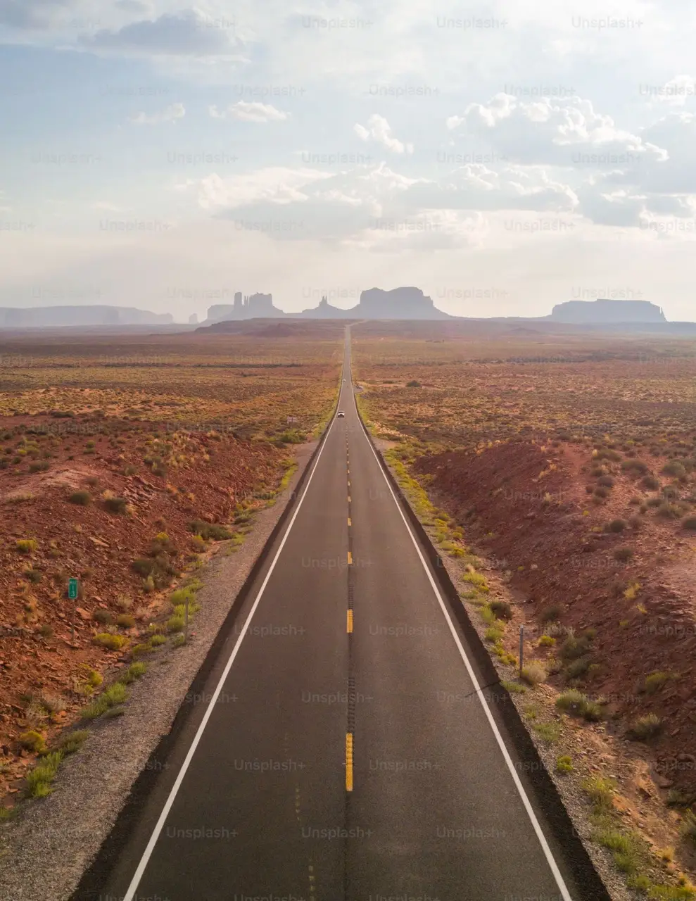 Open freeway in Texas with surrounding desert and mountains, typical road for car shipping.